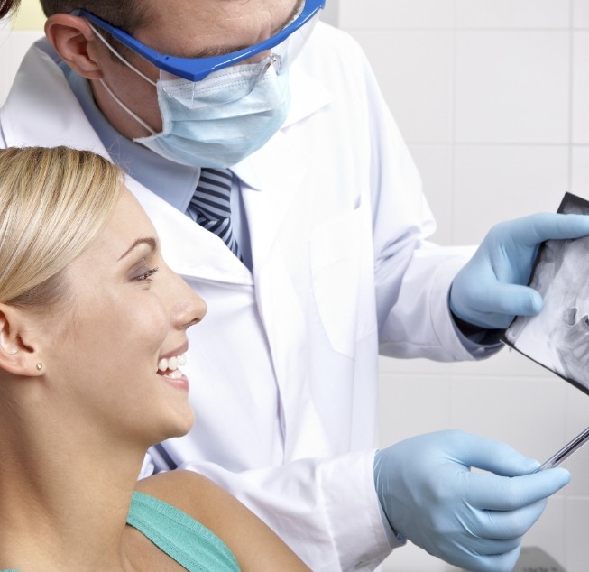 Dentist showing a screen to a patient