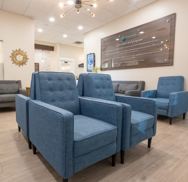 Blue armchairs in waiting area of dental office in Hanford