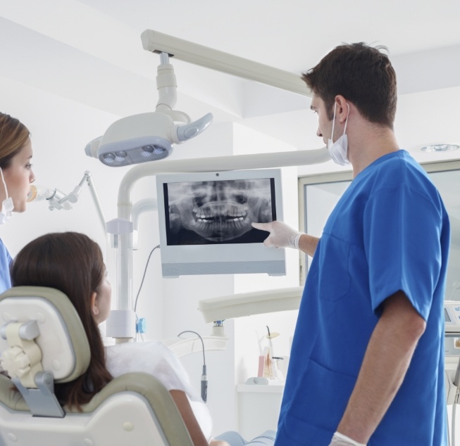 Dentist showing a patient x rays of their teeth