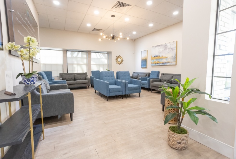 Several blue armchairs in dental office waiting area