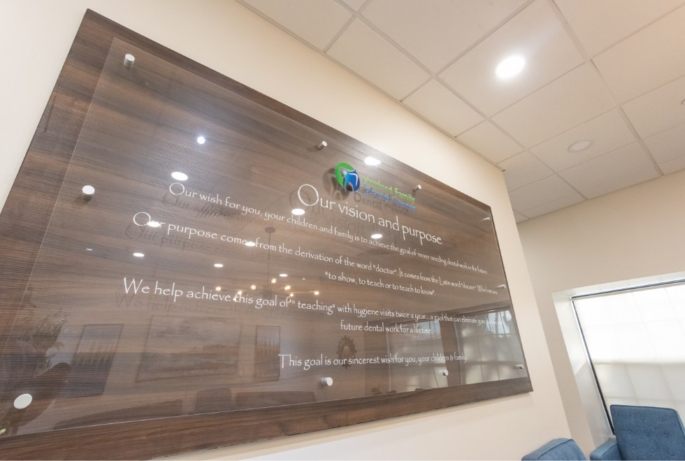 Wooden sign now all with mission statement for Hanford Family Dental Center