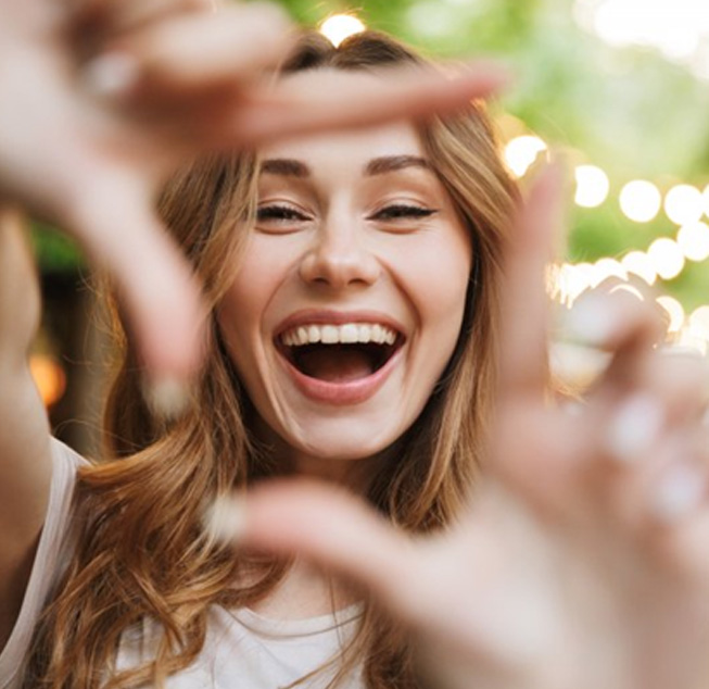 Woman outlining her smile with her fingers