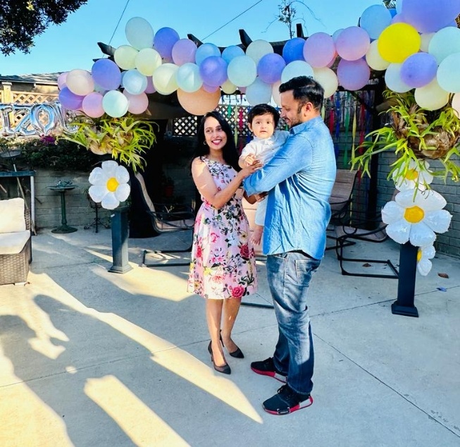 Doctor Parveen with her husband and child at a party with balloons