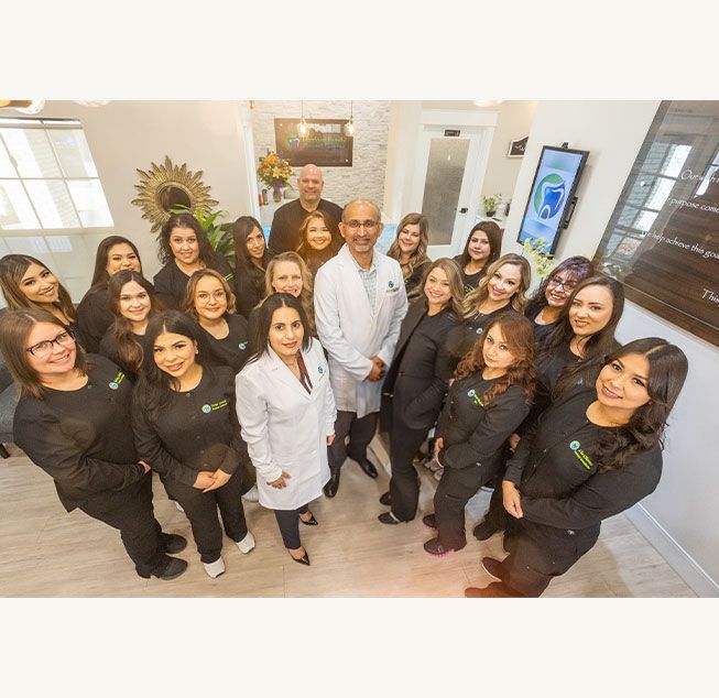 Smiling Hanford Family Dental Center team in reception area