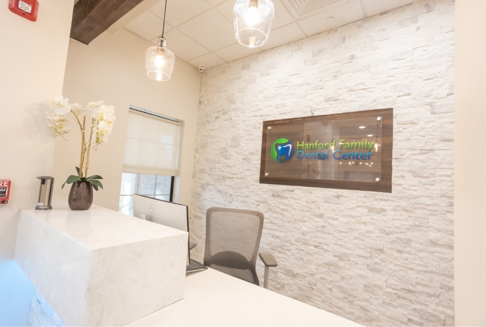 Hanford Family Dental Center sign on wall behind front desk