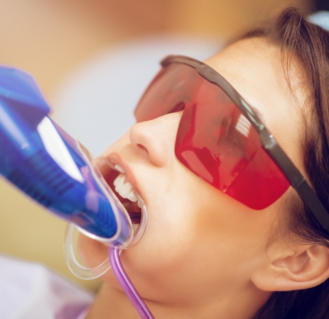 Young dental patient getting fluoride applied to their teeth