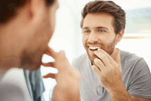 a patient examining their smile in a mirror
