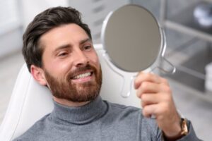 Man looking at his cosmetic dentistry results